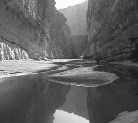 Black and white photograph of the Rio Grande running through the Elena Canyon